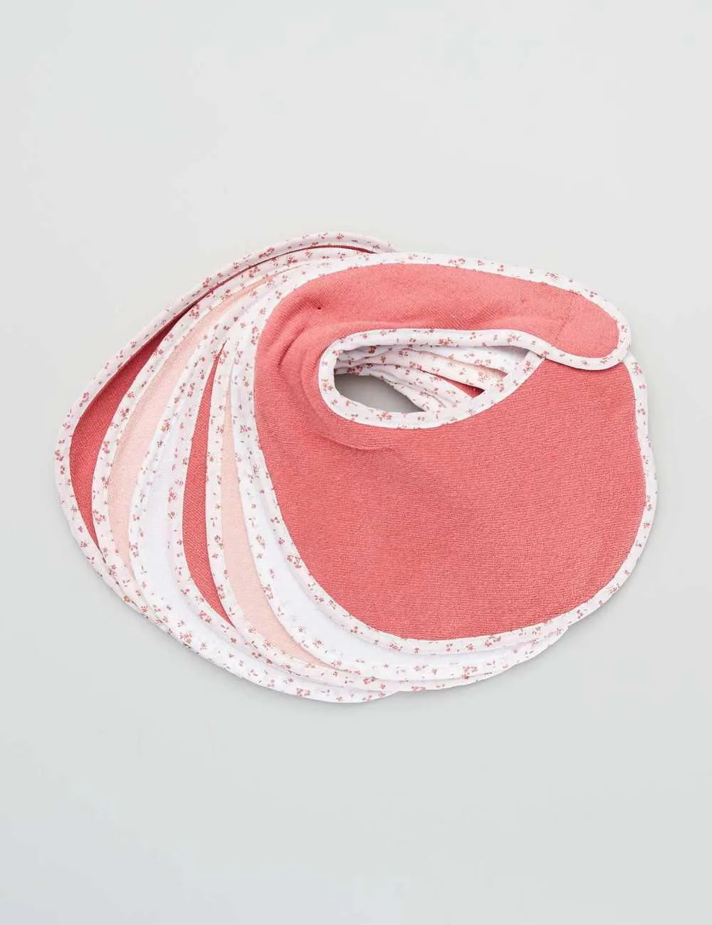 Pack of 7 towelling bibs with hook and loop fastening