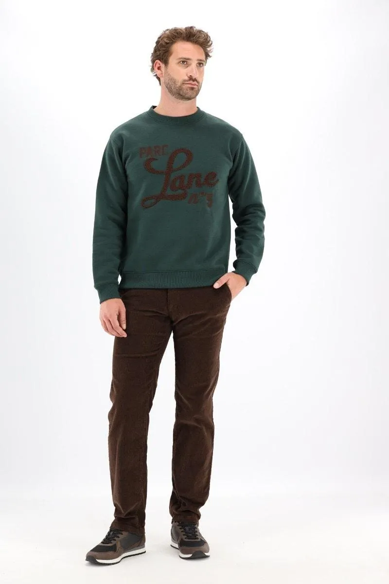 Donkergroene sweater met borduurwerk