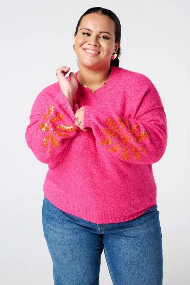 Gebreide trui met pailletten op de mouwen