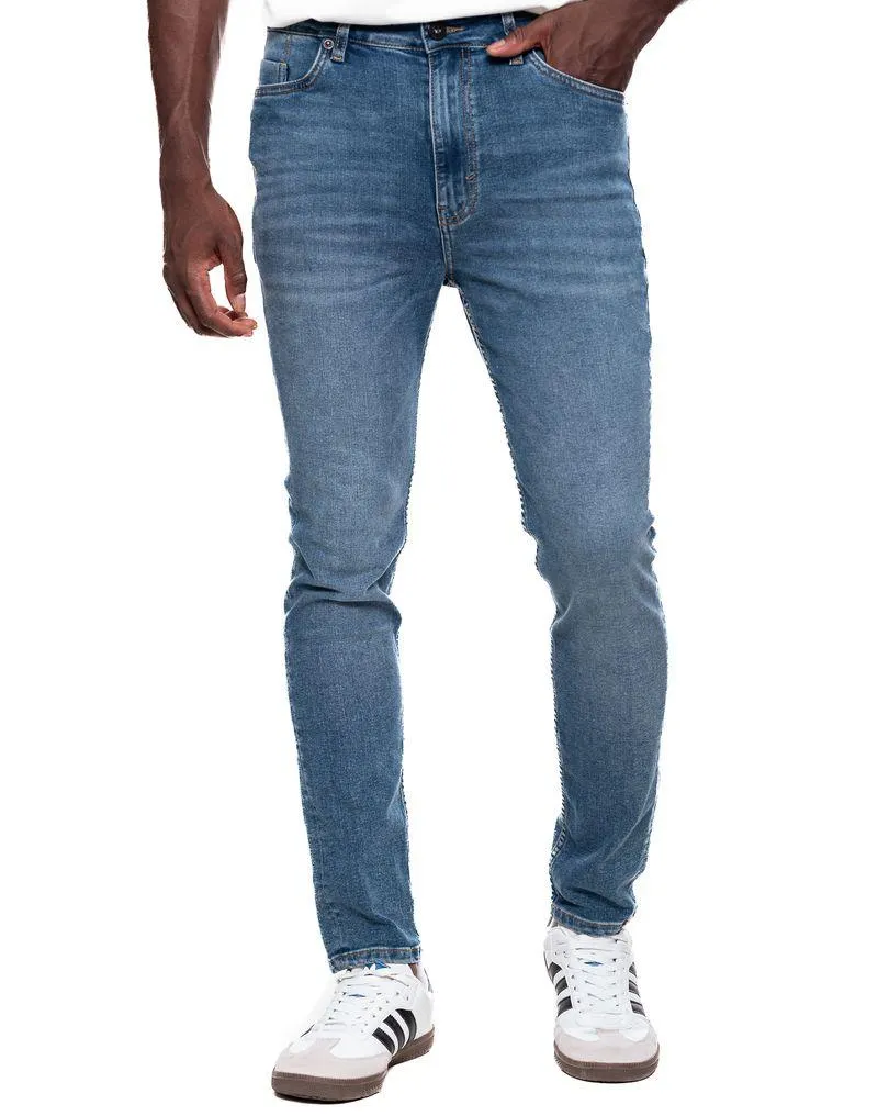Skinny Fit Jeans Tono Medio Con Desgastes