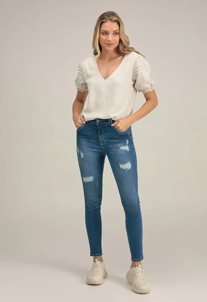 Jean reductor tiro alto con desgastes bota tubo