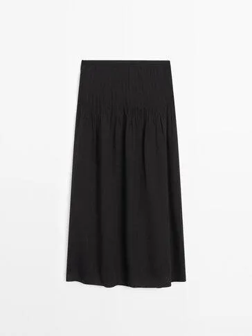 Splývavá sukně se sklady z lněné směsi