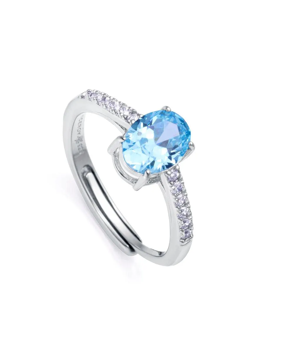 Anillo Clásica de plata de ley con baño de rodio , circonita color aguamarina y circonitas blancas