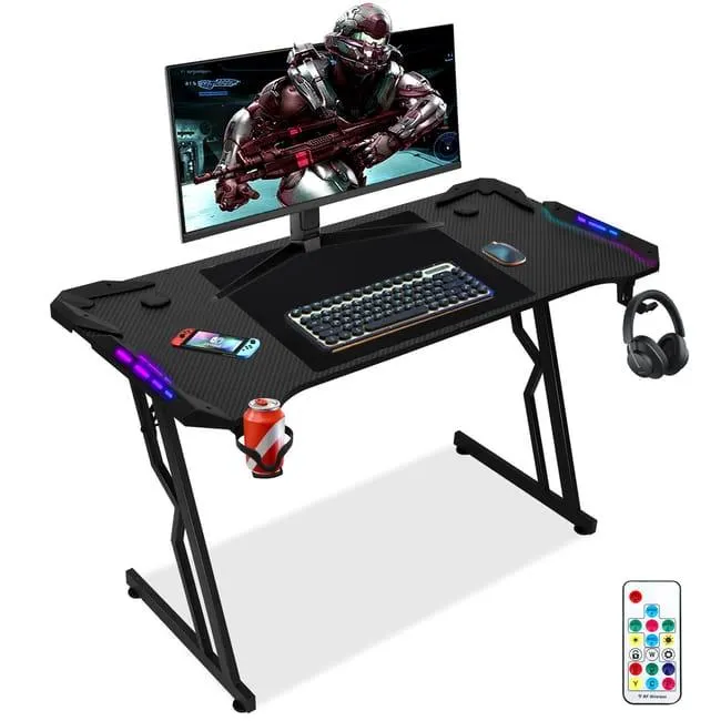Escritorio Gaming de 140 x 60 cm con luz LED, forma de Z, soporte para monitor, portavasos, gancho para auriculares, negro carbón