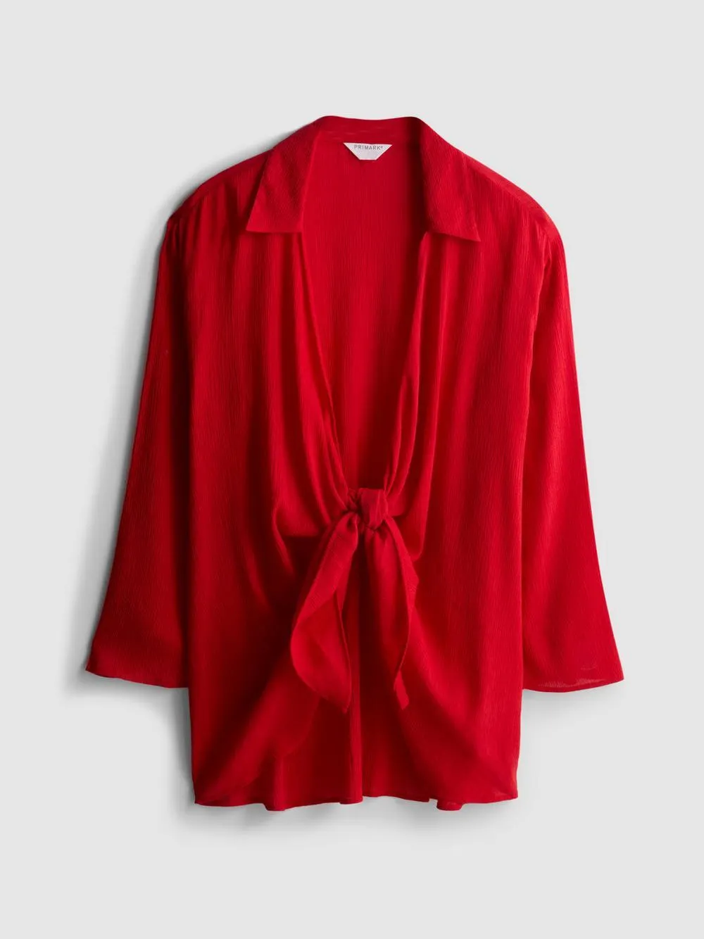 Camisa playera con nudo delantero