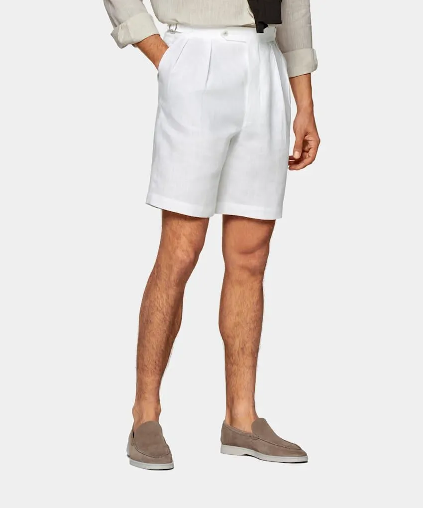 Cut above the knee with a high-rise waist, these white Mira shorts feature a wide leg & inverted pleats for an elevated summery vibe infused with a hint of 50's Italian appeal.