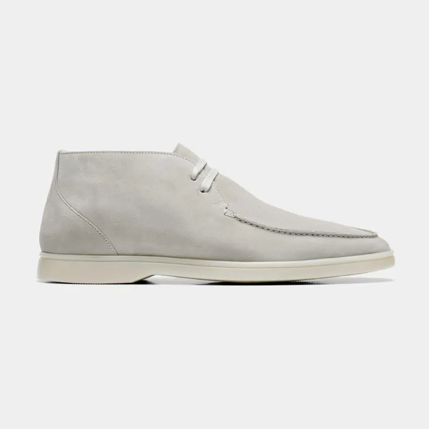 Seamlessly adapting to laid-back and elevated casual styles, these light grey chukka boots are crafted in double-faced suede with an apron toe and slip-resistant rubber sole.