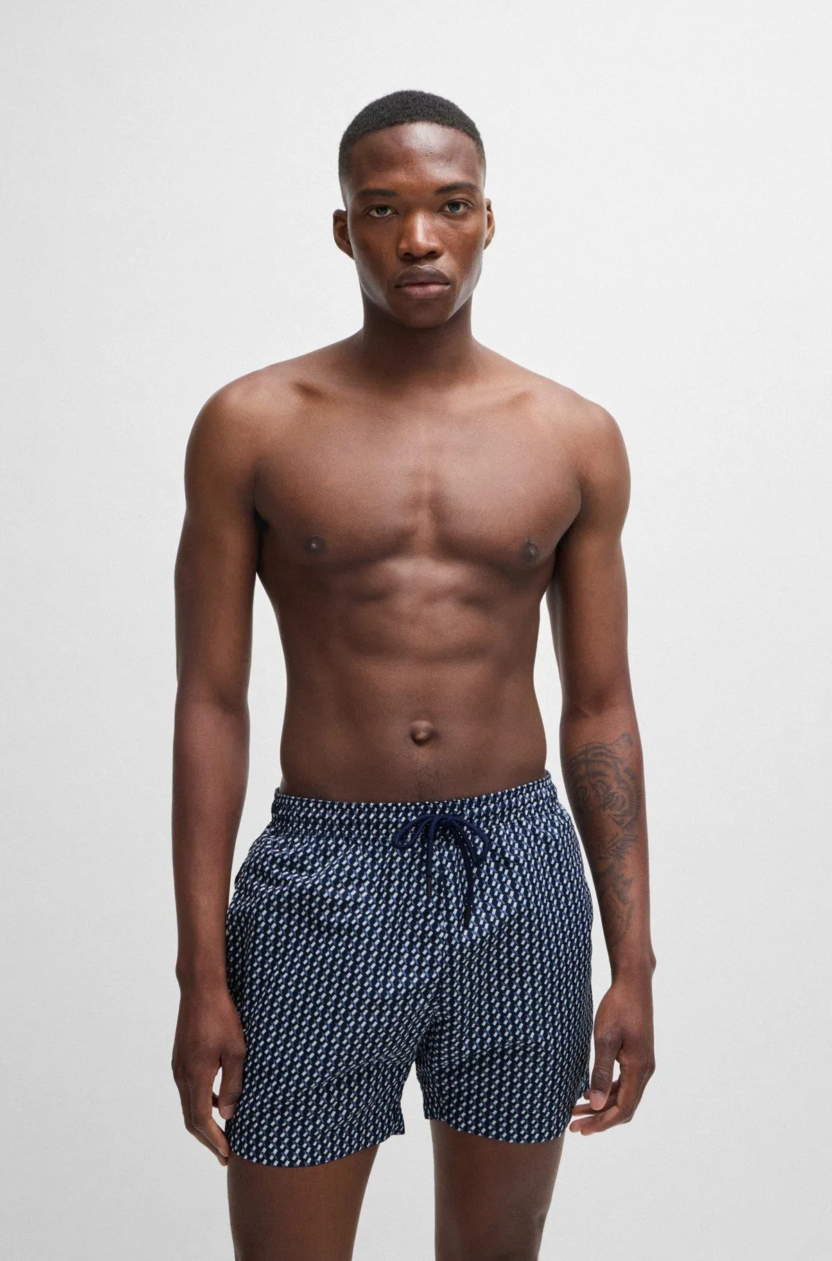 Logo-label swim shorts with seasonal pattern