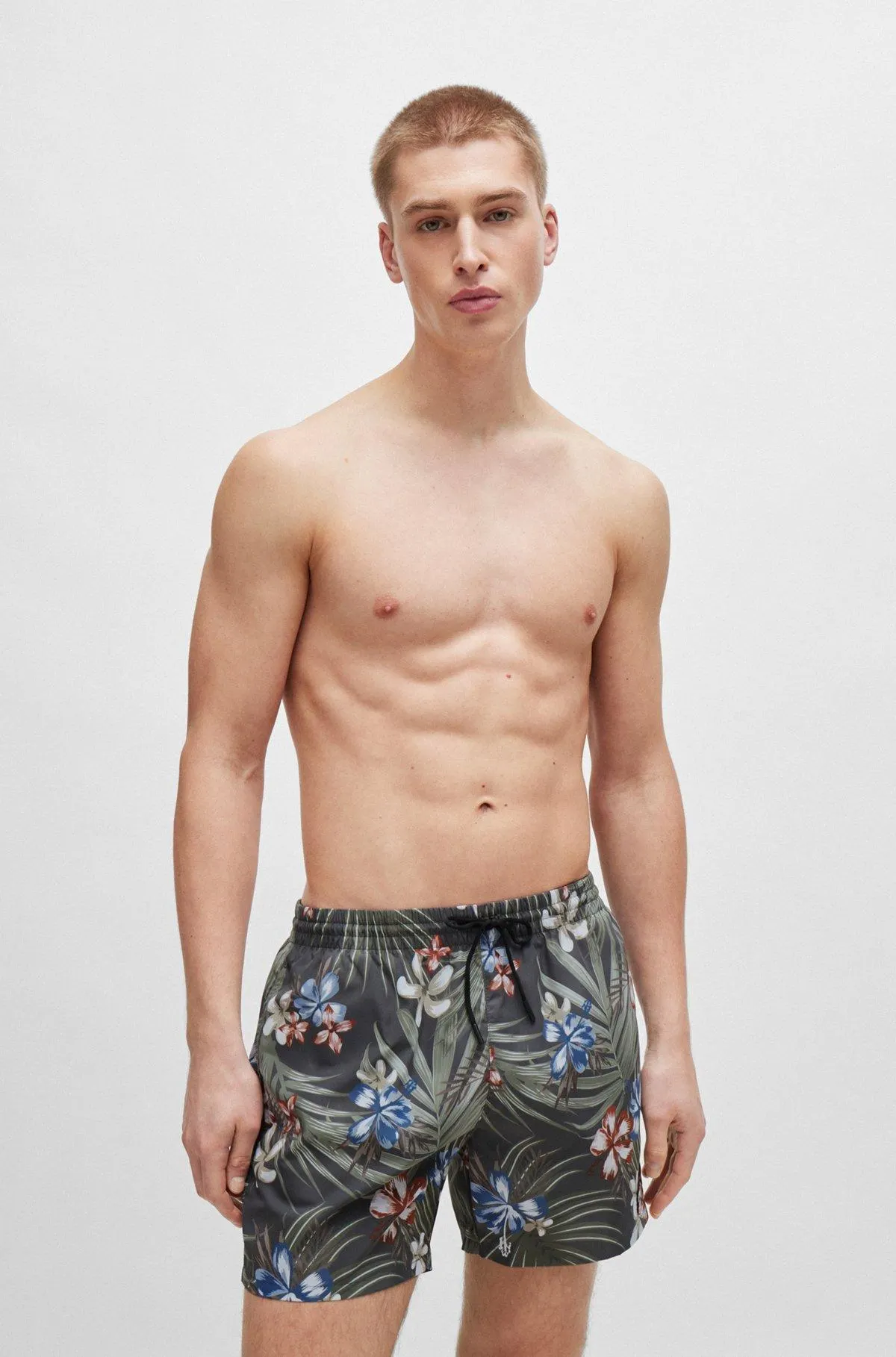 Tropical-print quick-drying swim shorts with logo badge
