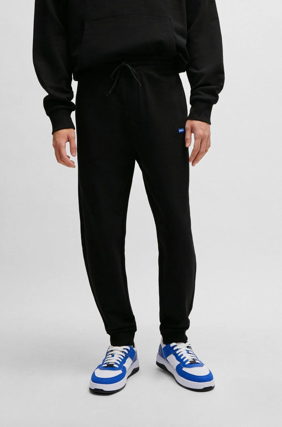 Cotton-terry tracksuit bottoms with blue logo patch