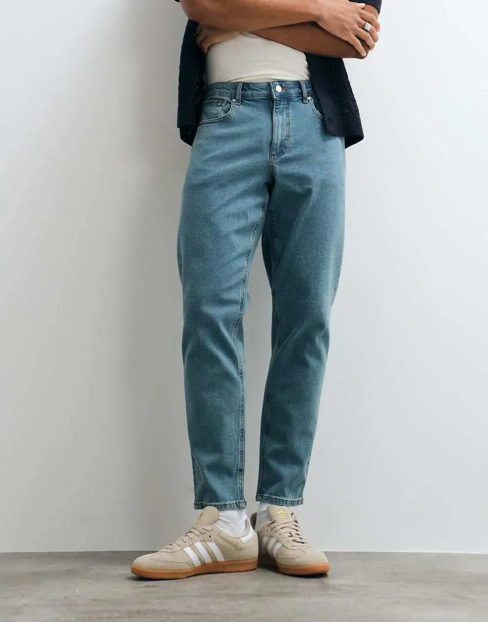 ASOS DESIGN stretch tapered jeans in tinted light wash blue