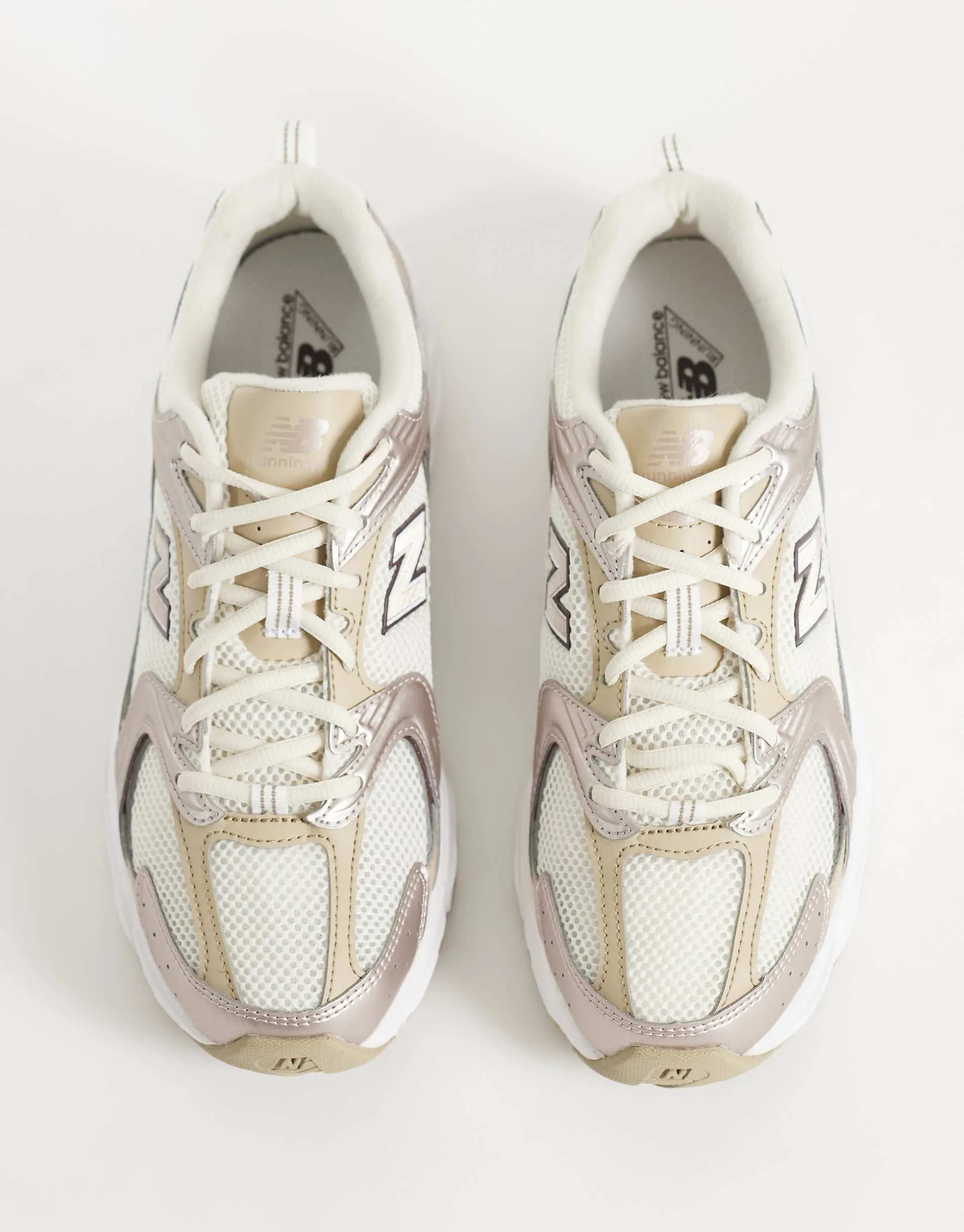 New Balance 530 trainers in white and metallic bronze