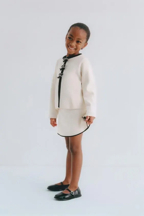 KNIT SKIRT WITH CONTRAST BOWS