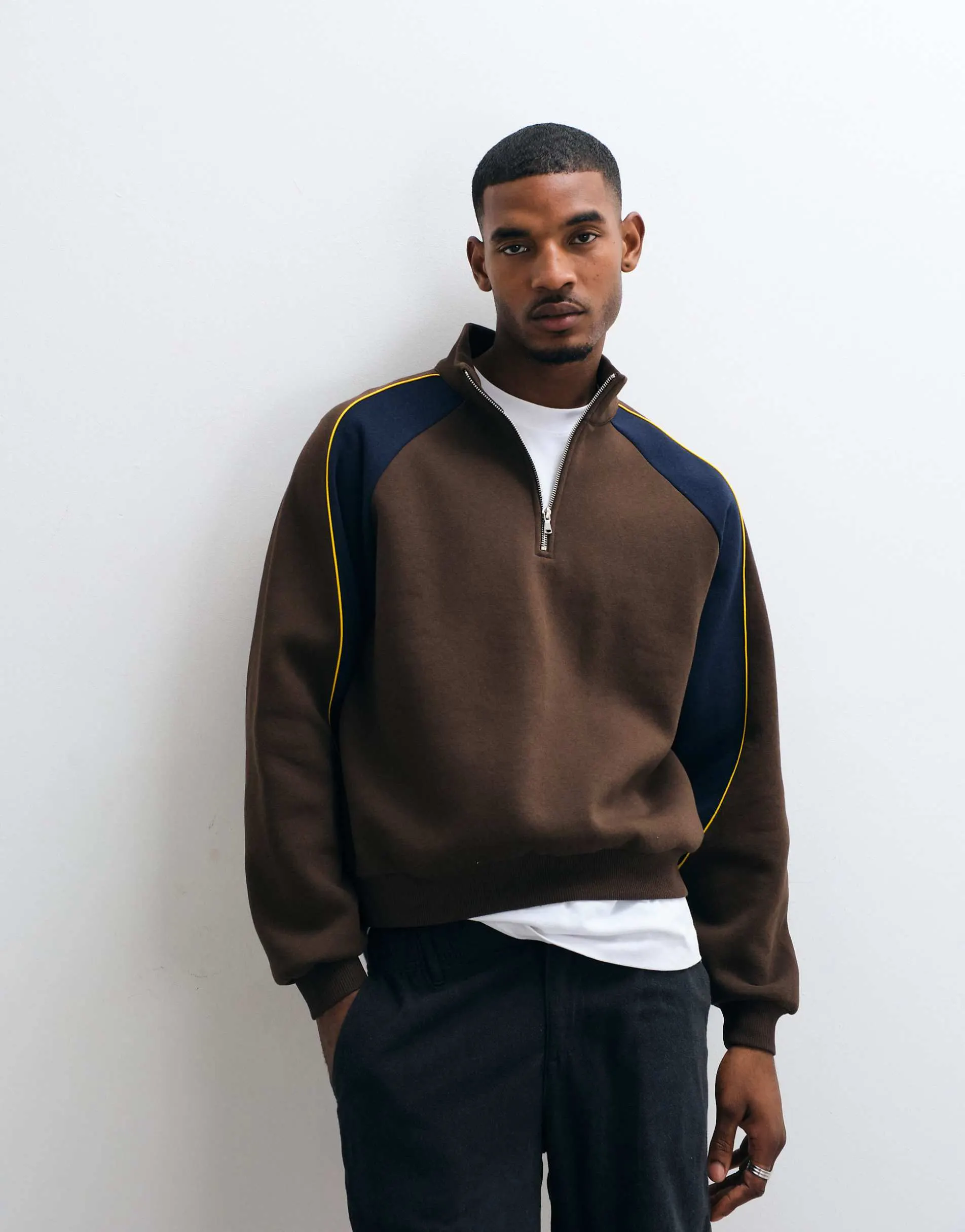 ASOS DESIGN relaxed 1/4 zip with cut & sew panelling and contrast piping in brown
