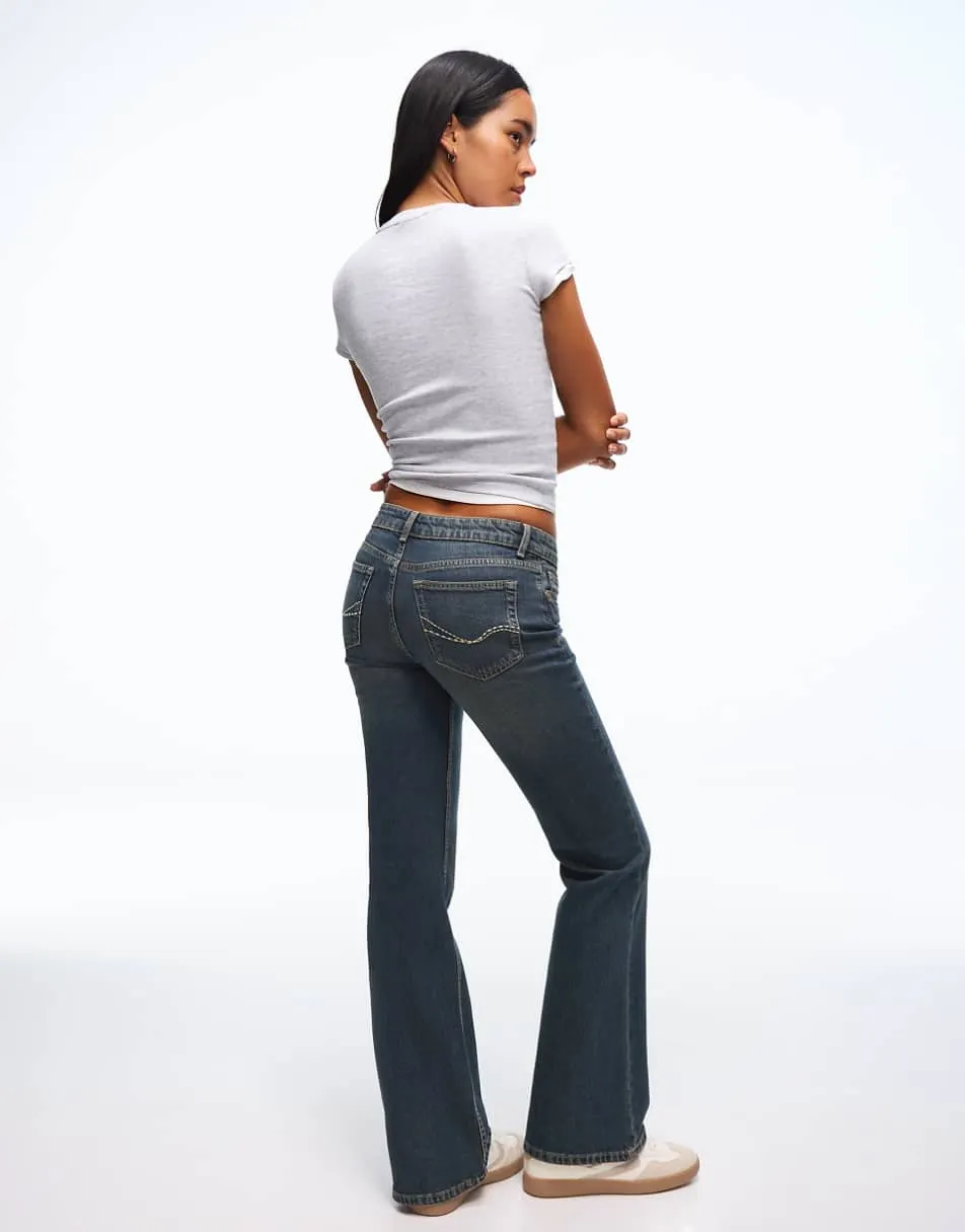 Bershka Petite low waist bootcut jeans in denim blue