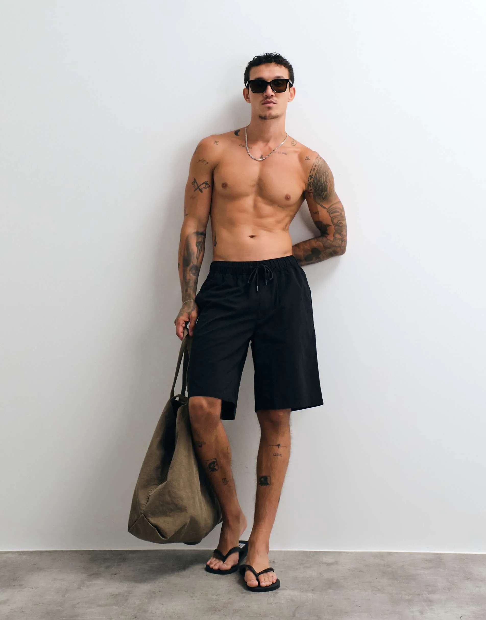 ASOS DESIGN swim shorts in long length in black
