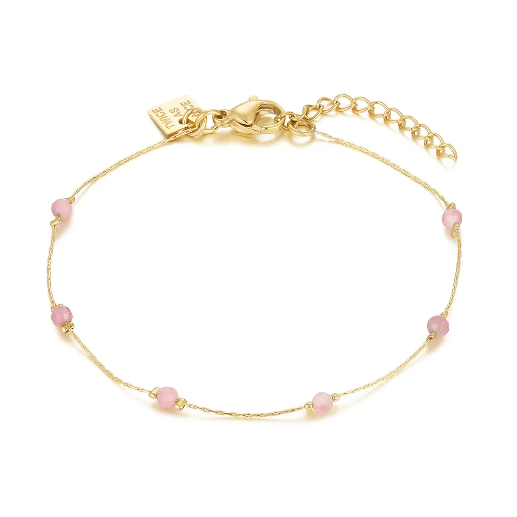 Armband in goudkleurig edelstaal, roze steentjes