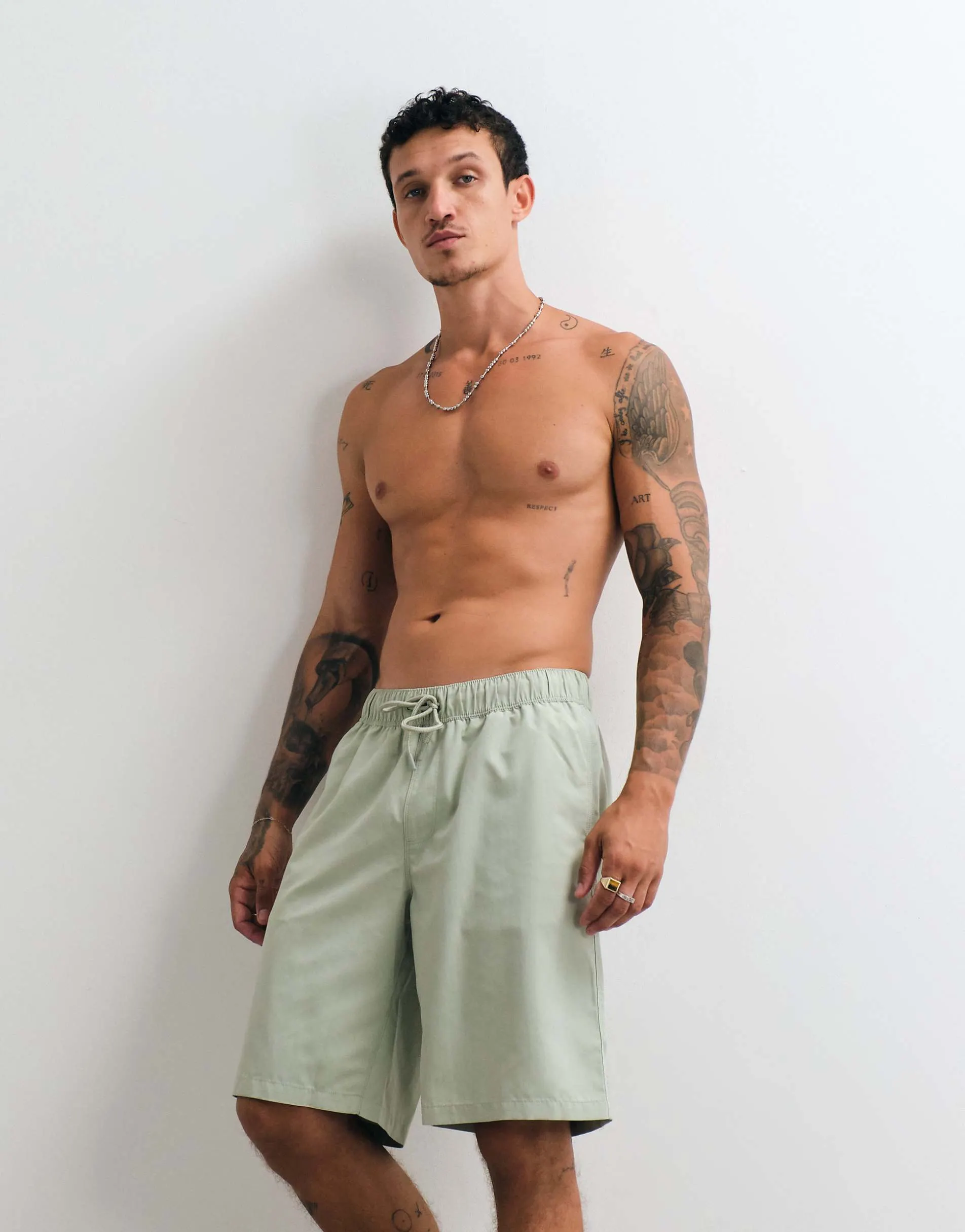 ASOS DESIGN swim shorts in long length in sage green