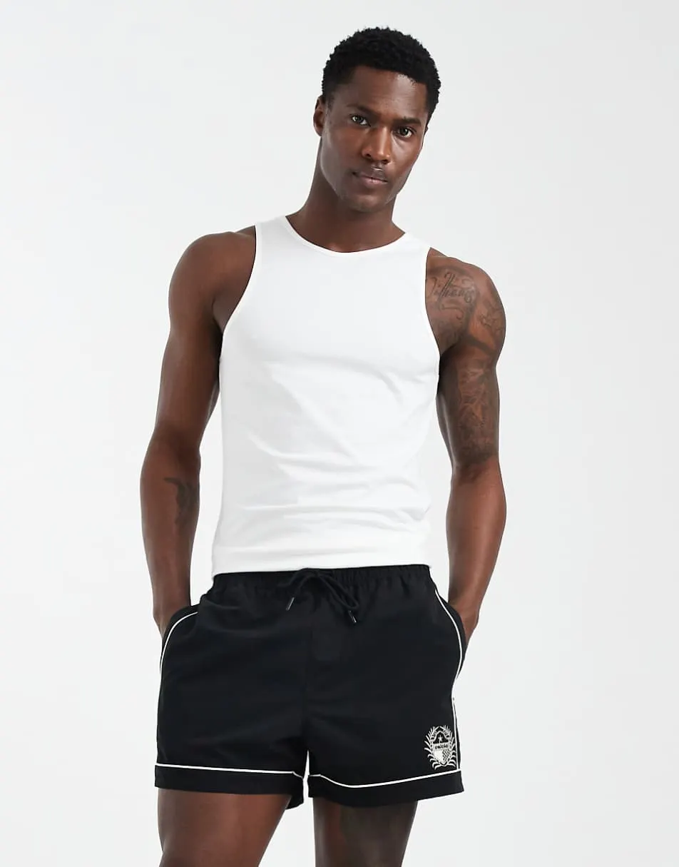 ASOS DESIGN swim shorts in short length with piping and embroidery in black