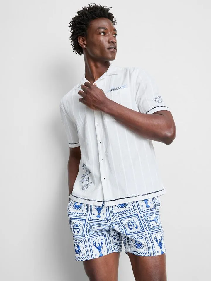 Chemise à col à revers et poissons brodés