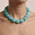 Halsketting in edelstaal, turquoise kralen