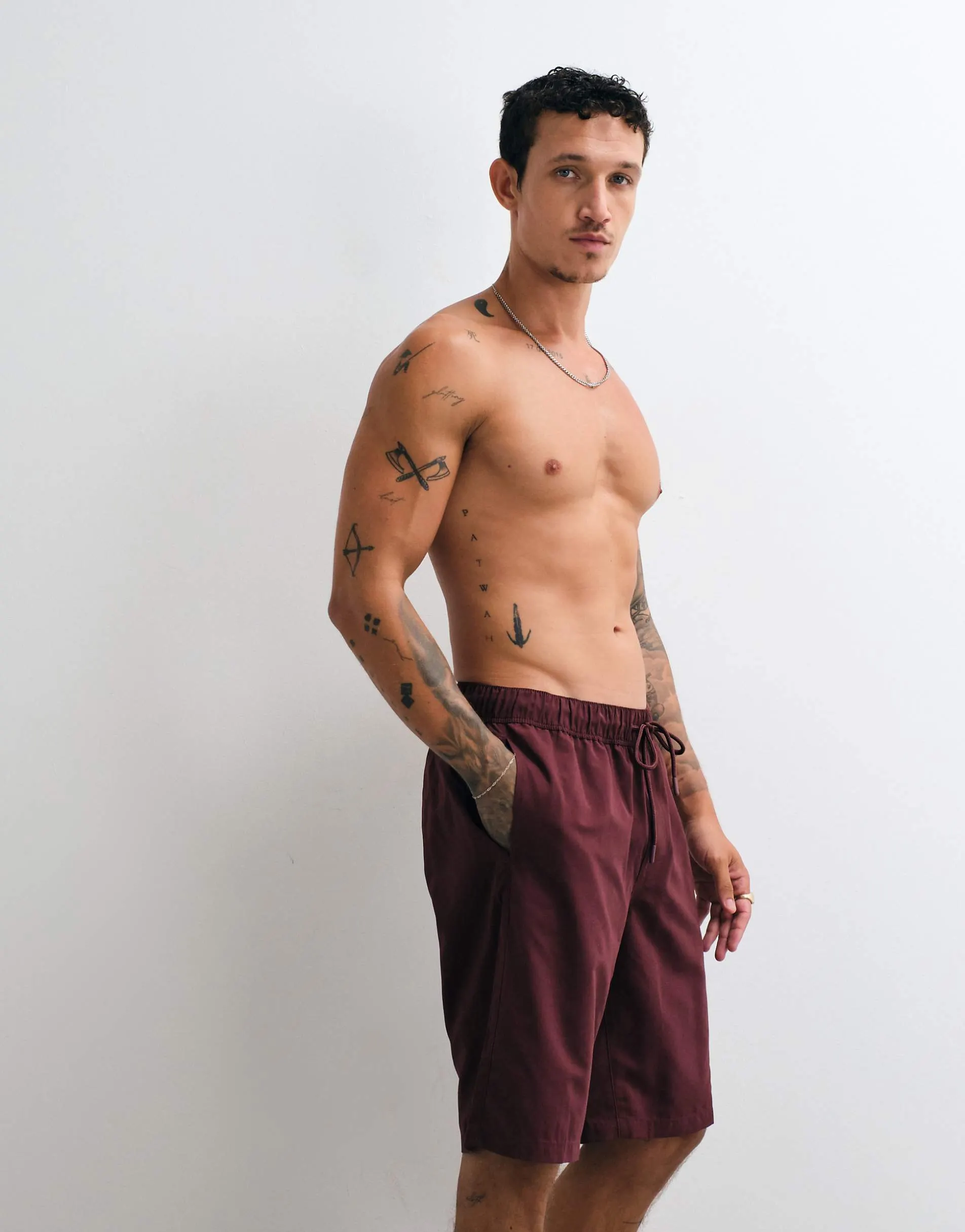 ASOS DESIGN swim shorts in long length in burgundy