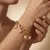 Armband in edelstaal met zon-, ster- en hartbedels