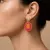 Oorbel in high fashion, oranje en roze steentjes