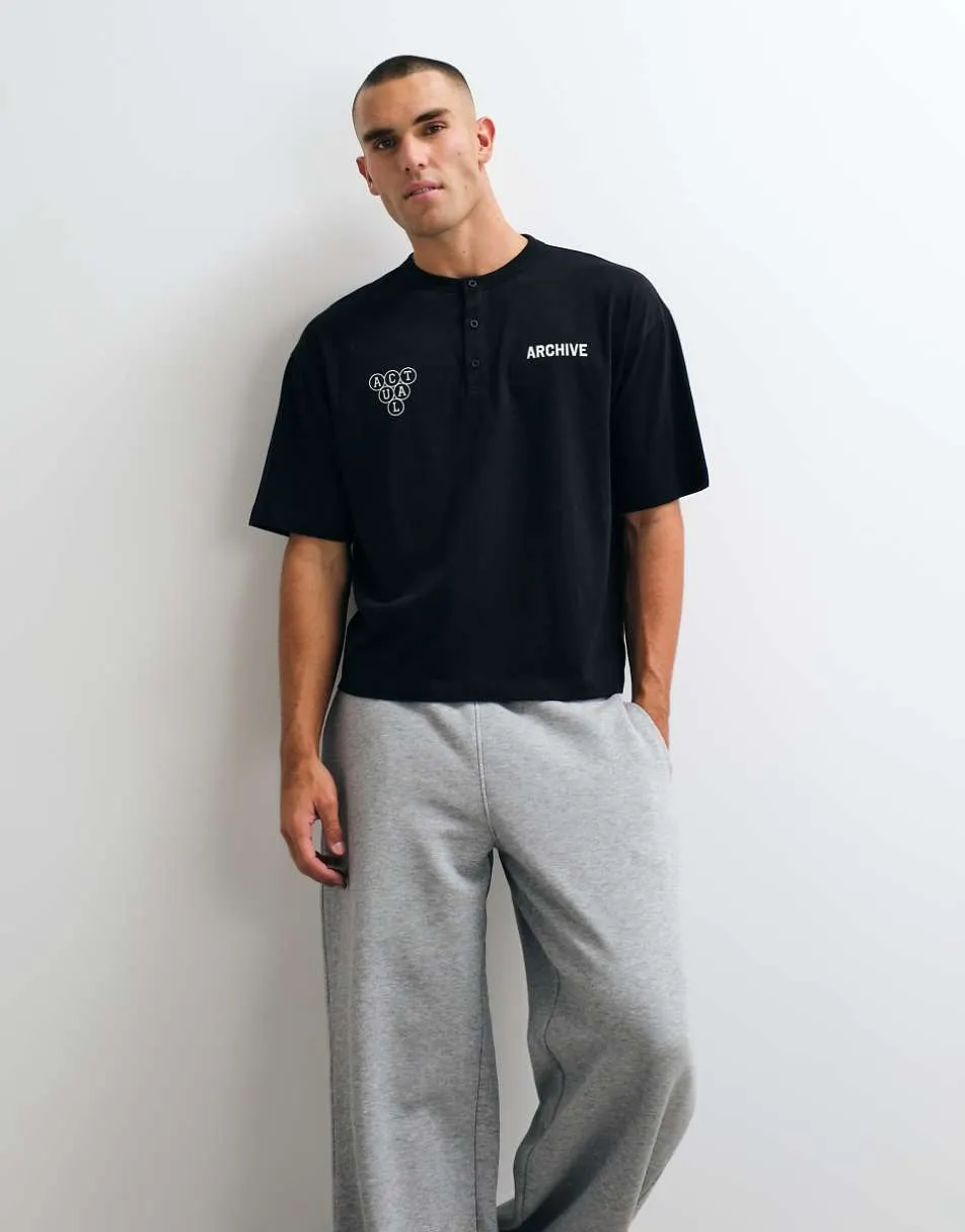 ASOS DESIGN boxy oversized henley t-shirt with text graphic in black