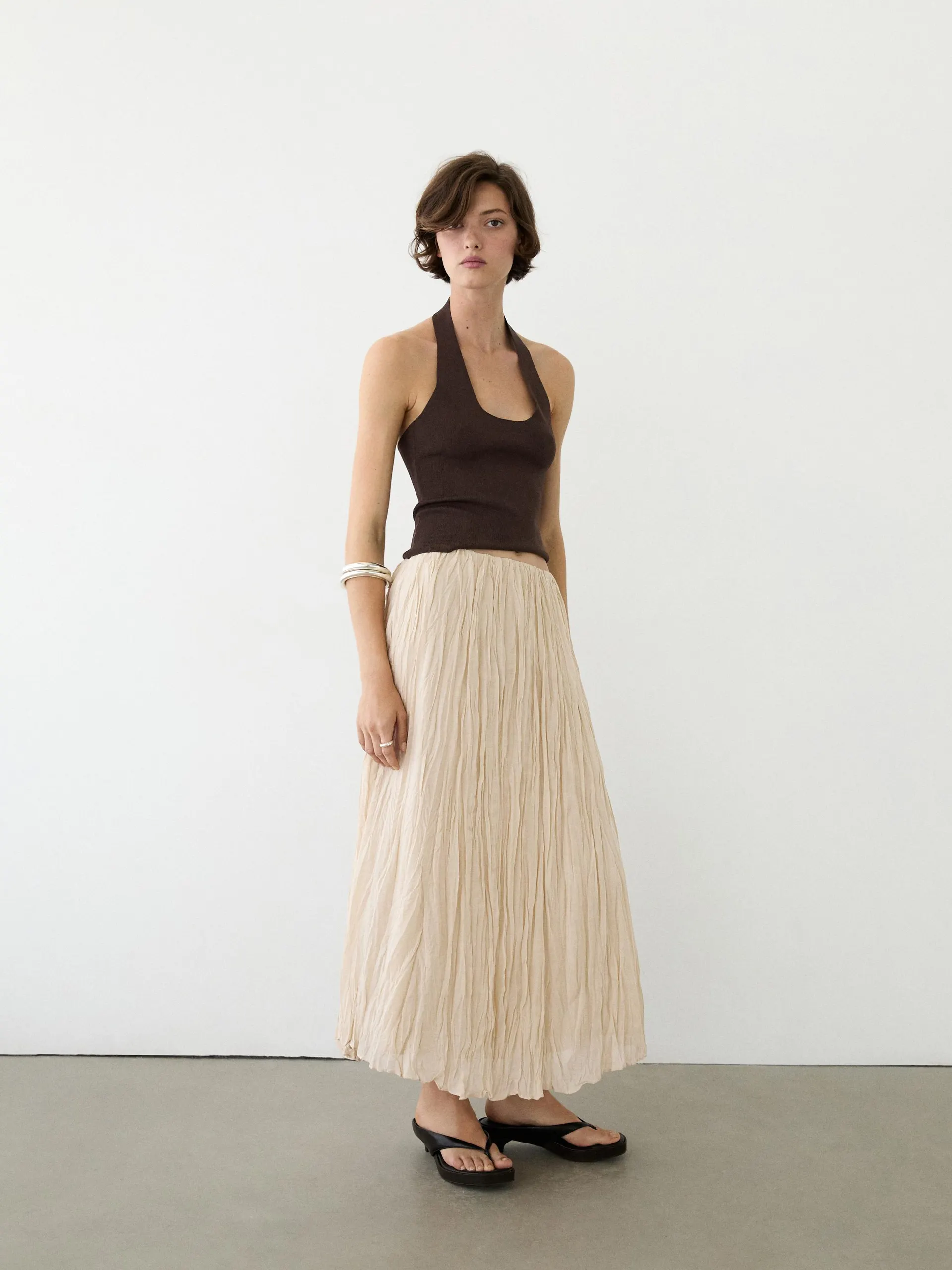 Splývavá midi sukně s detailem skladů