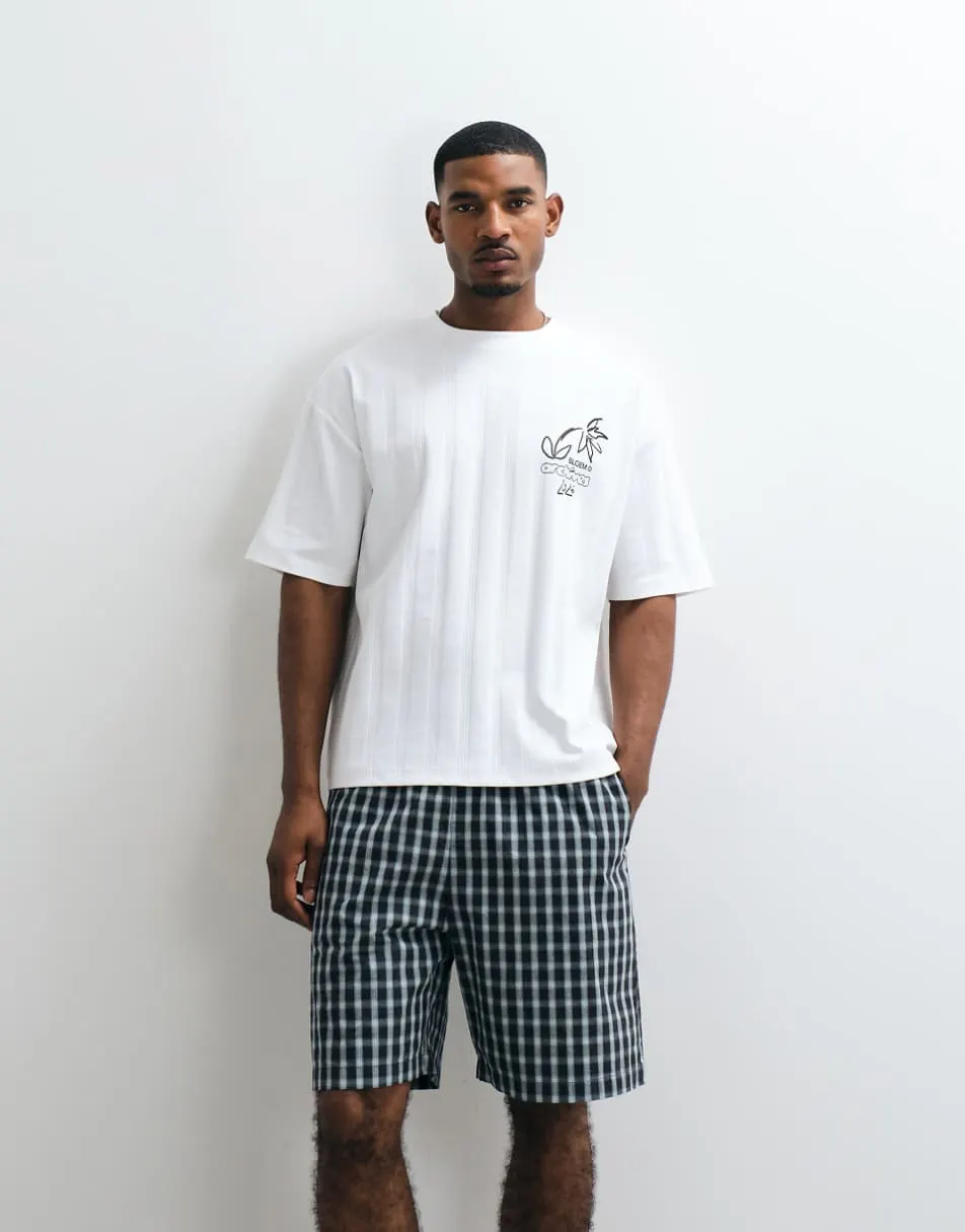 ASOS DESIGN heavyweight oversized tshirt with floral chest graphic in white textured fabric