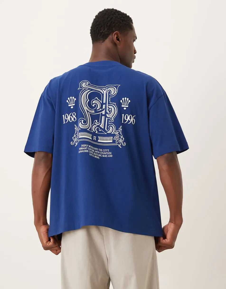 ASOS DESIGN oversized t-shirt with text and crest graphic in blue
