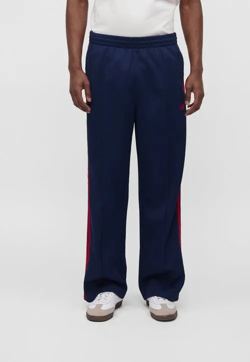FIREBIRD LOOSE TRACK PANTS UNISEX - Wide leg - night indigo/better scarlet