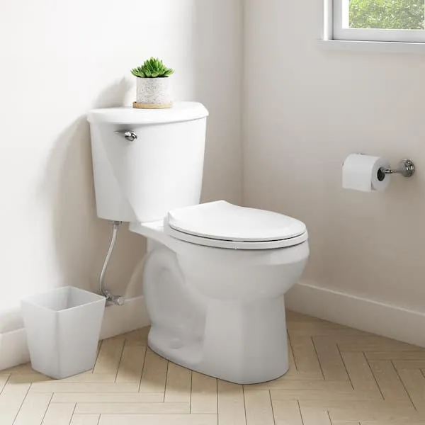 American Standard Reliant 12 in.​ Rough In 2-​Piece 1.​28 GPF Single Flush Round Toilet with Slow Close Seat in White
