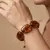 Armband in edelstaal, grote bruine kralen