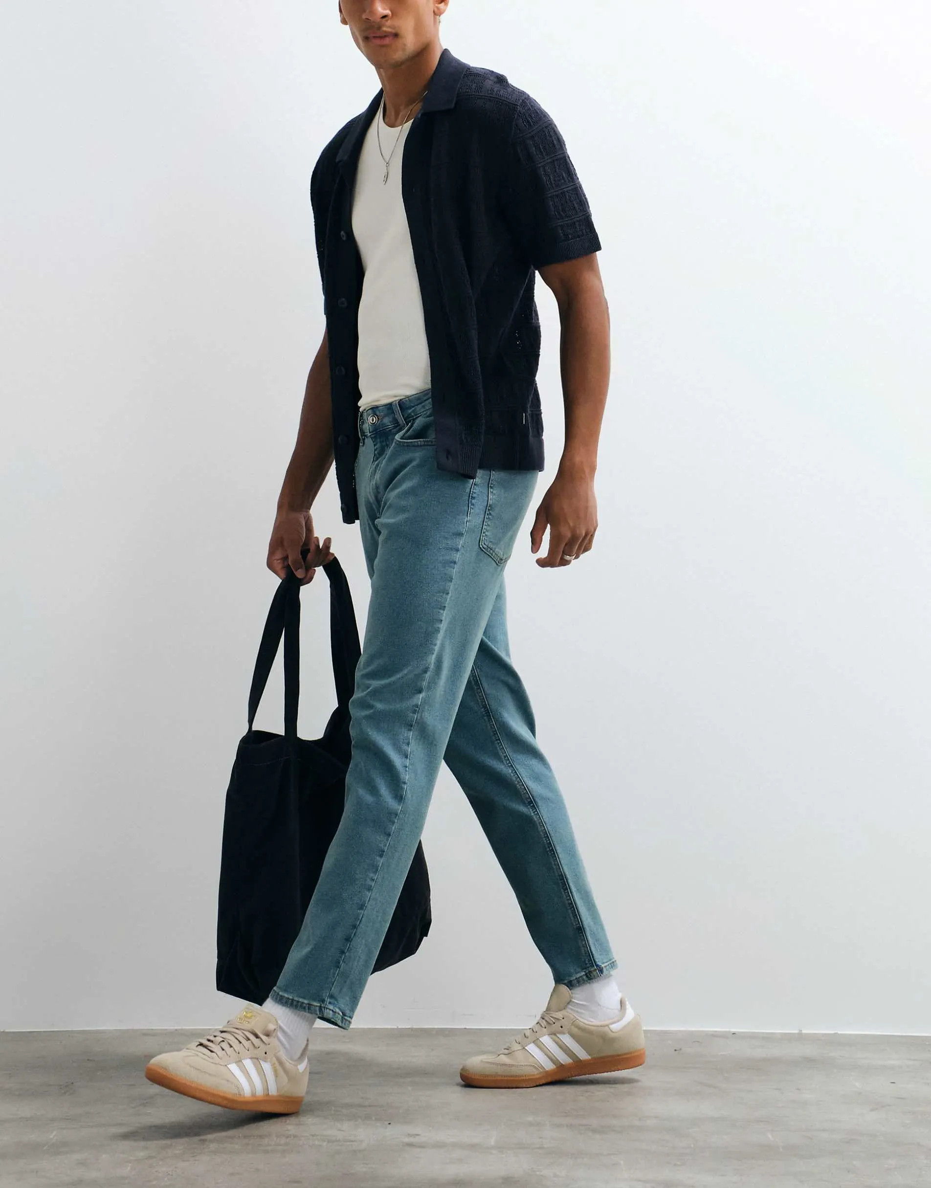 ASOS DESIGN stretch tapered jeans in tinted light wash blue