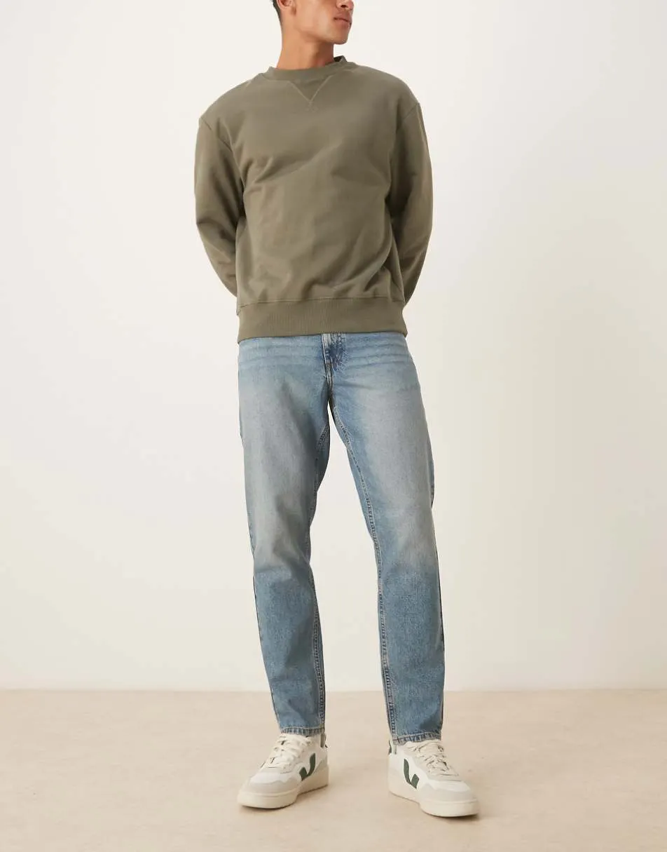 ASOS DESIGN tapered jeans in mid wash blue