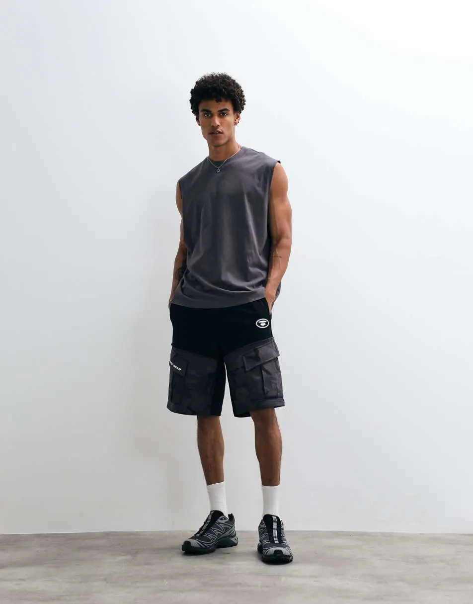 Aape by A Bathing Ape loose fit jersey motocross shorts in black with camo pockets