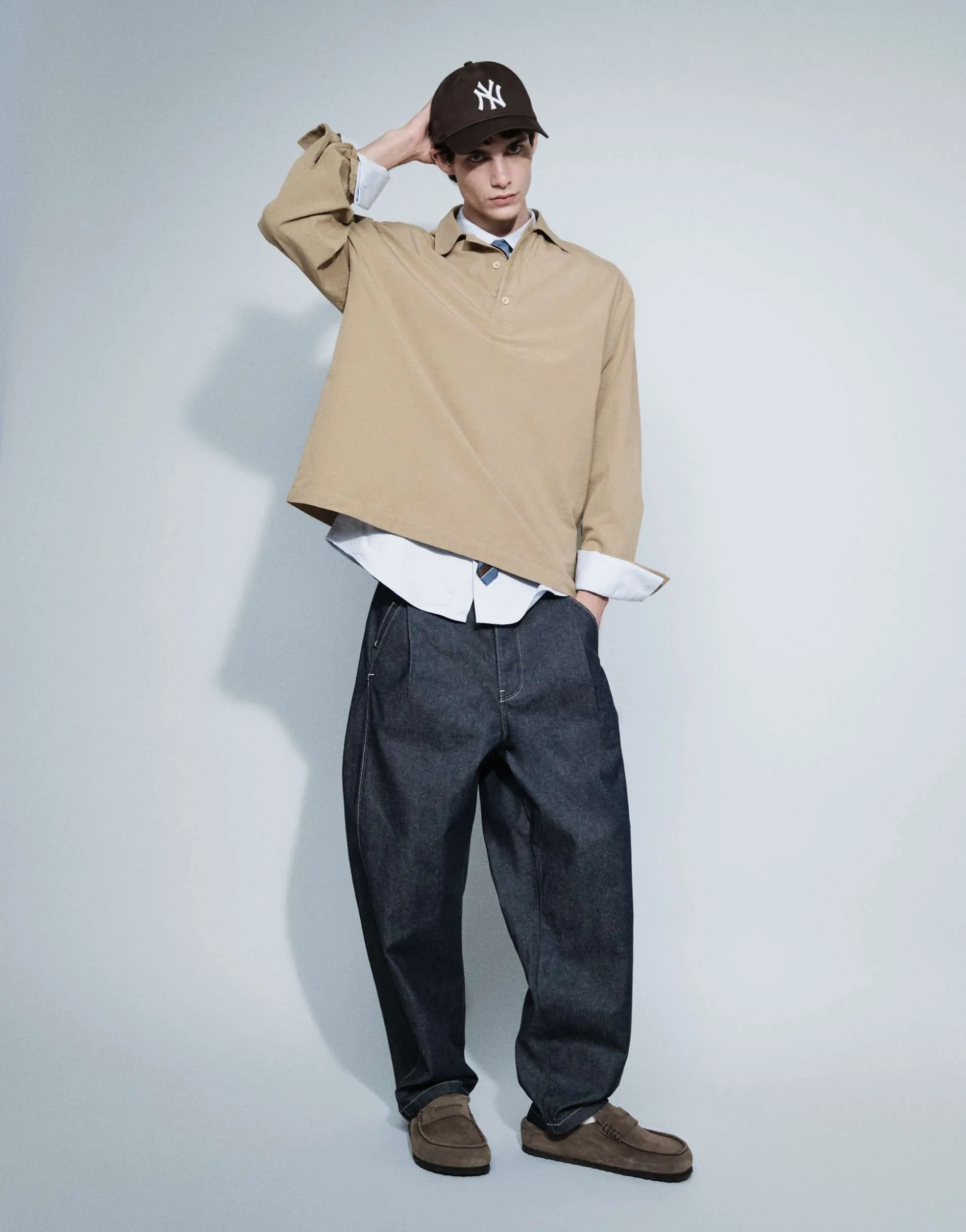ASOS DESIGN relaxed tapered jeans in raw denim with pleats and buckle