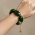 Armband in edelstaal, groene kralen