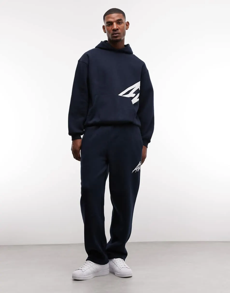 ASOS DESIGN co-ord oversized hoodie and straight leg jogger with text print in navy