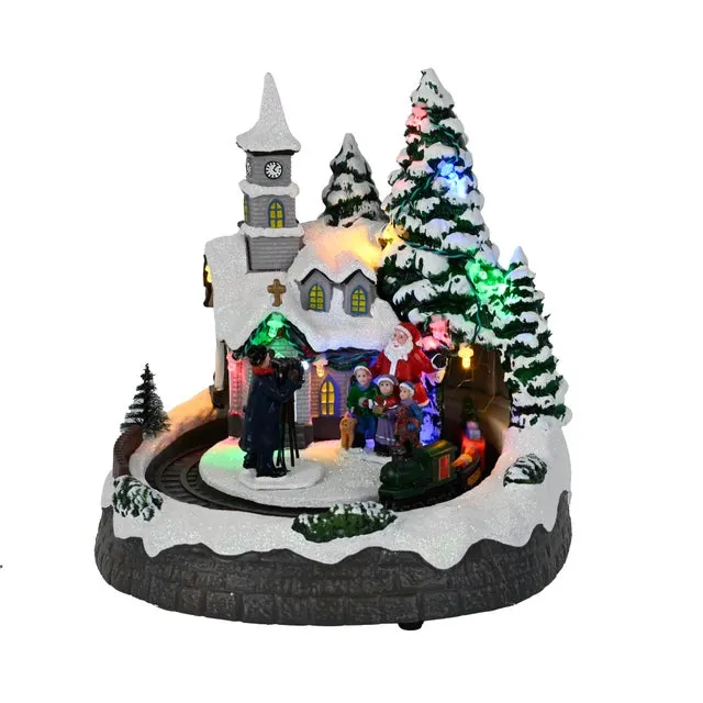Ciudad animada de Navidad de resina multicolor con iluminación LED musical