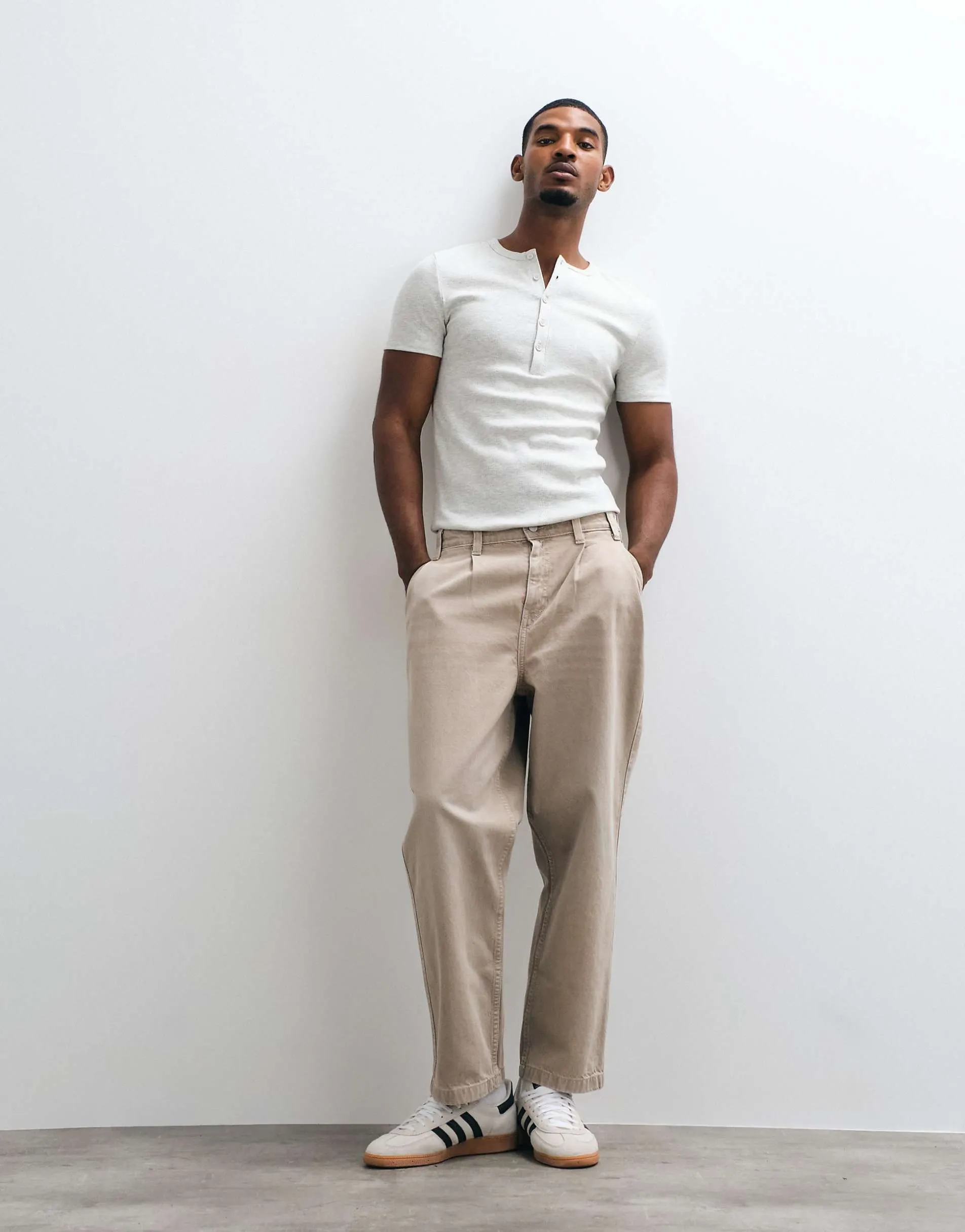 ASOS DESIGN relaxed tapered jeans in washed beige with pleats