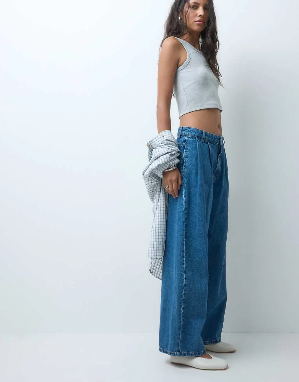 ASOS DESIGN pleat front horseshoe jean in midwash blue