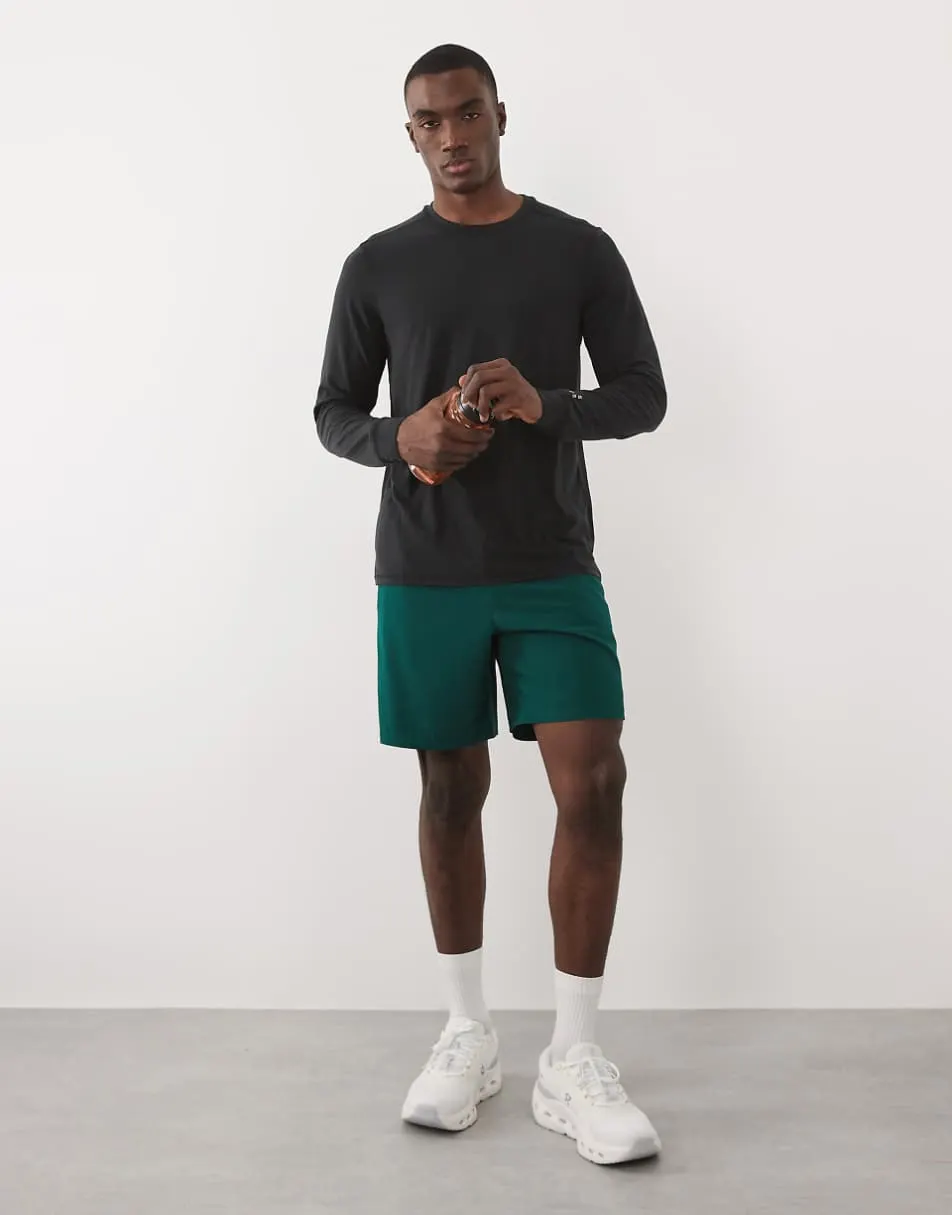 4505 7"" woven training shorts with elastic waist band and zip pockets in bottle green