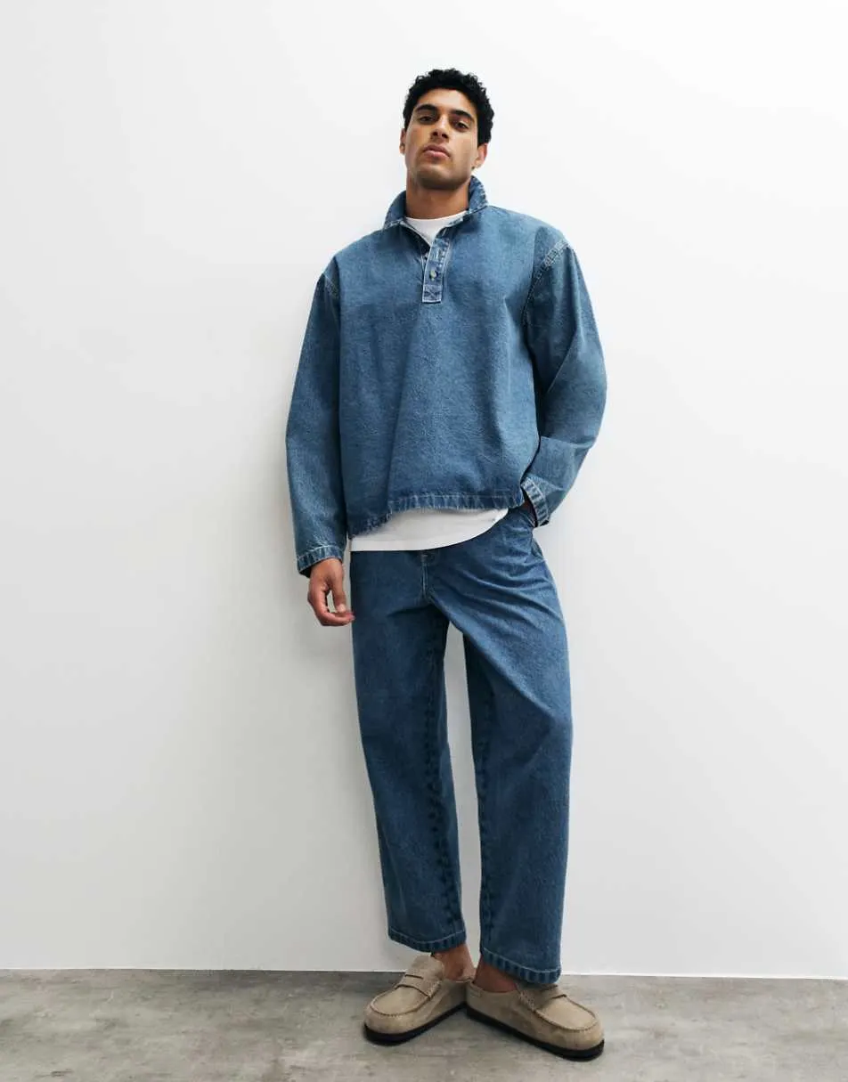 ASOS DESIGN relaxed tapered jeans in mid wash blue with pleats and buckle