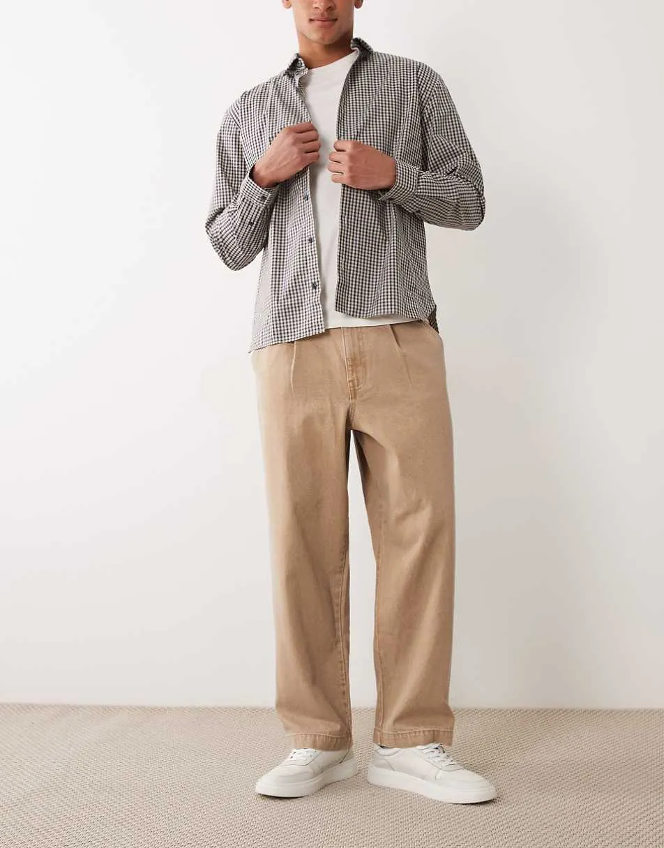 ASOS DESIGN relaxed tapered jeans in washed brown with pleats