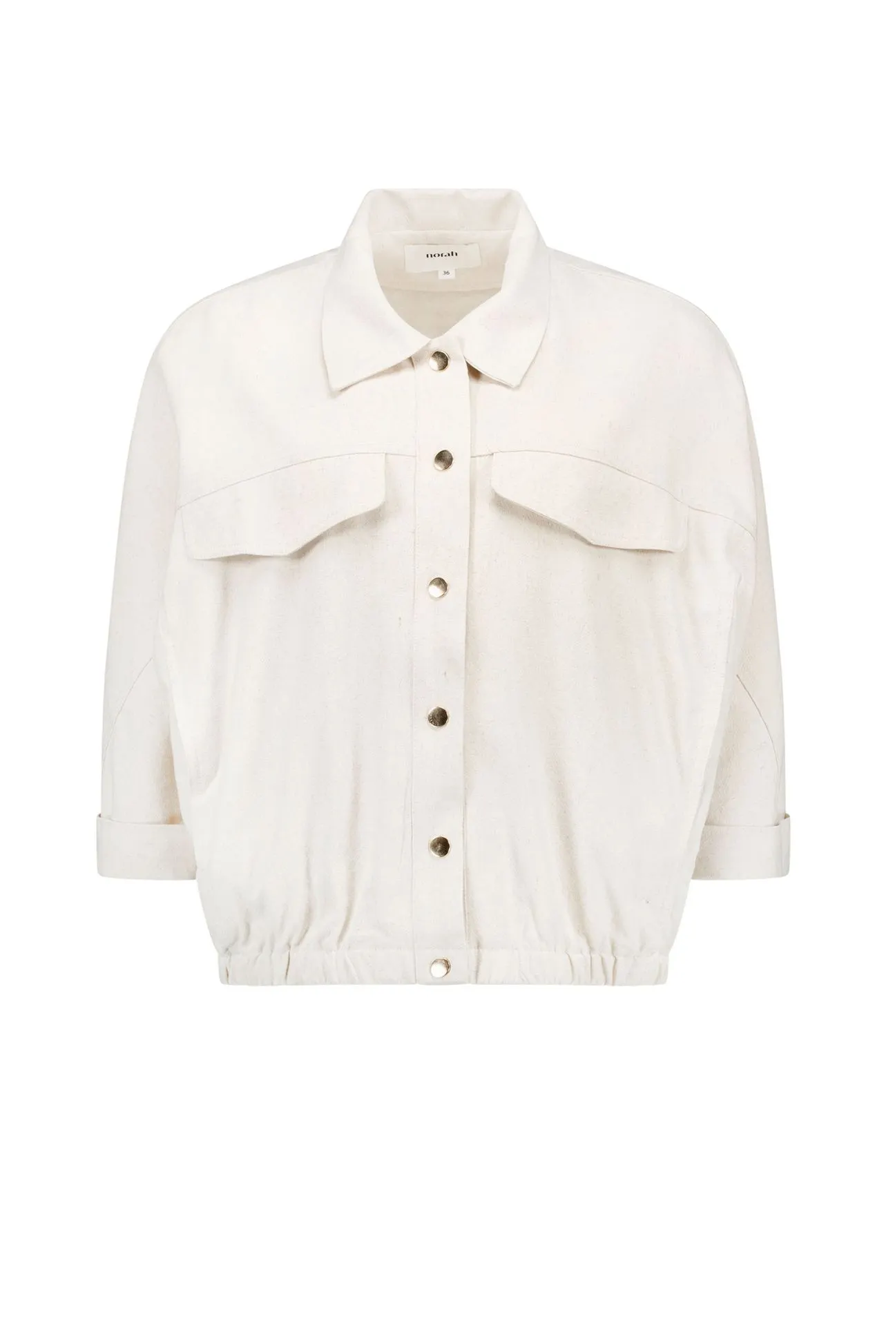 Zandkleurige blouse met goudkleurige knoopsluiting