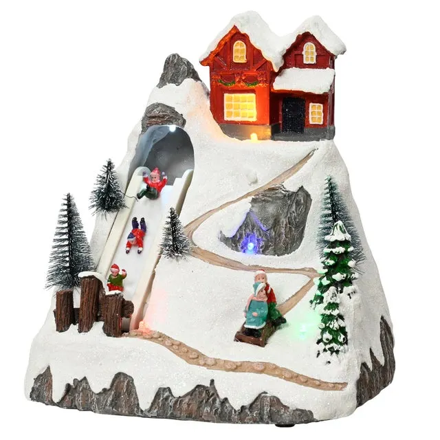 Ciudad animada de Navidad de PVC multicolor con iluminación LED 17x20x18 cm