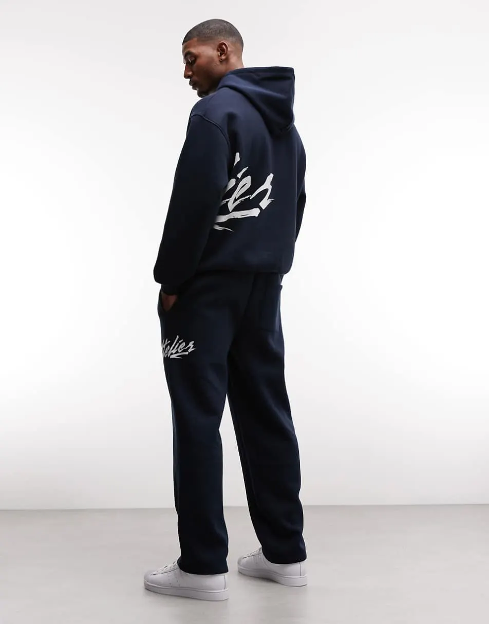 ASOS DESIGN straight leg jogger with text print in navy